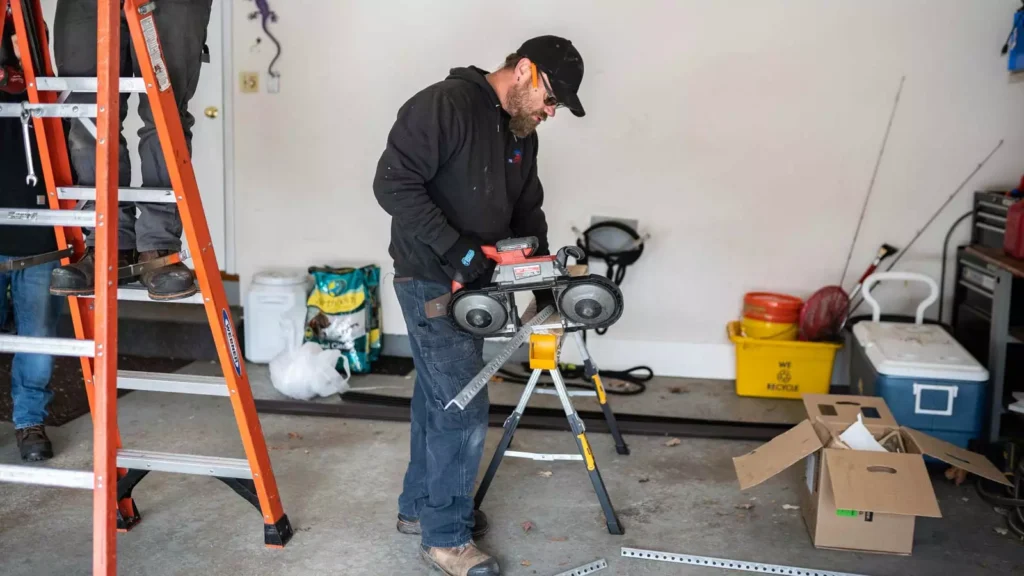 Technician installing garage door opener in Java Village home garage Technician installing garage door opener in Java Village home garage