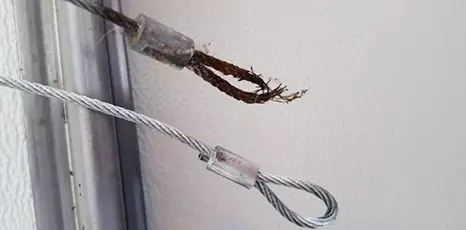 Worn, old garage door cable