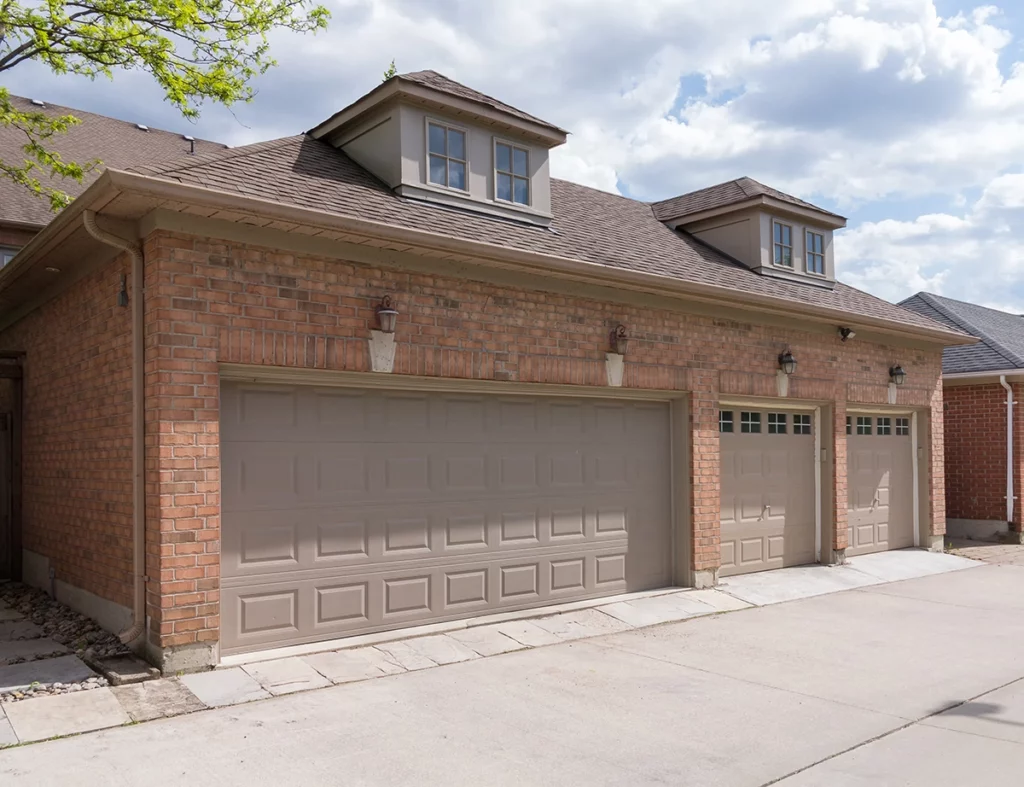 brick home with multiple car garage