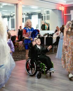 child on dancefloor in wheelchair