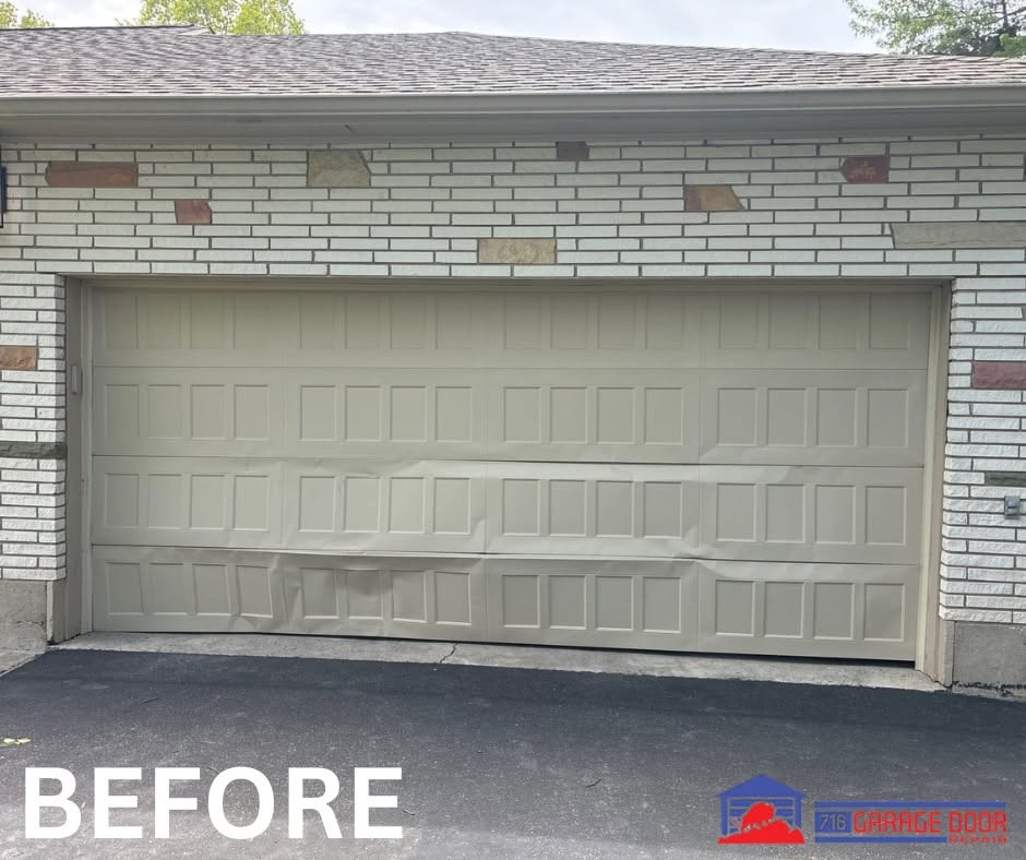 Beige garage door with dented and creased lower panels before replacement